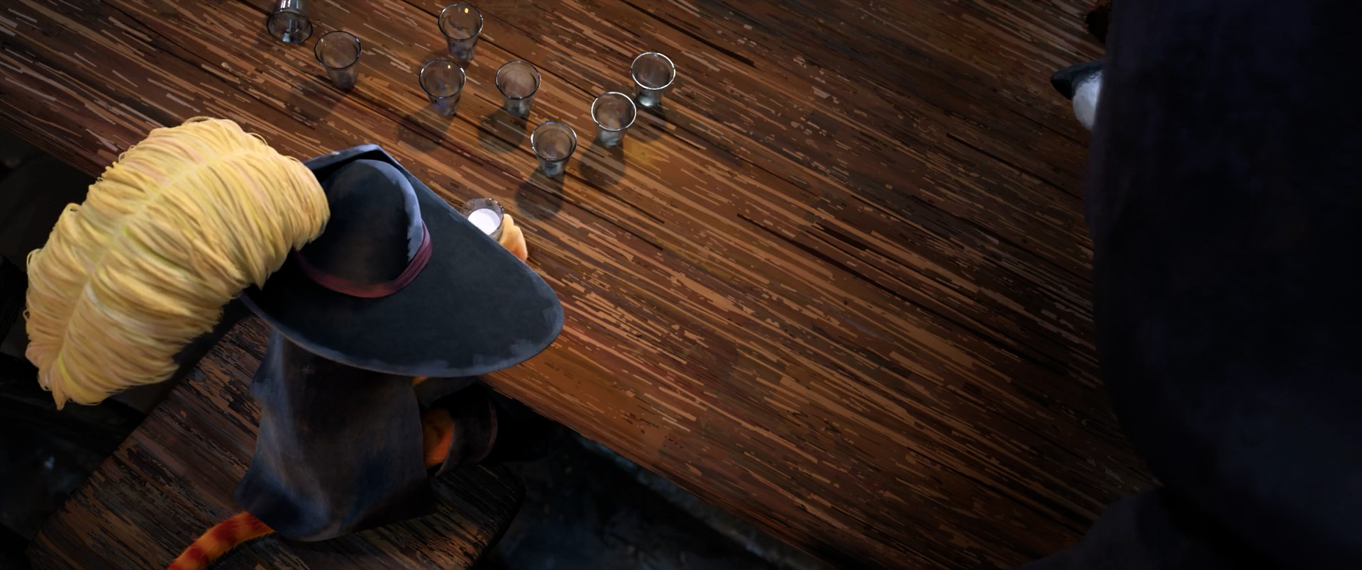 Eight empty cups in front of Puss in Boots in a bar